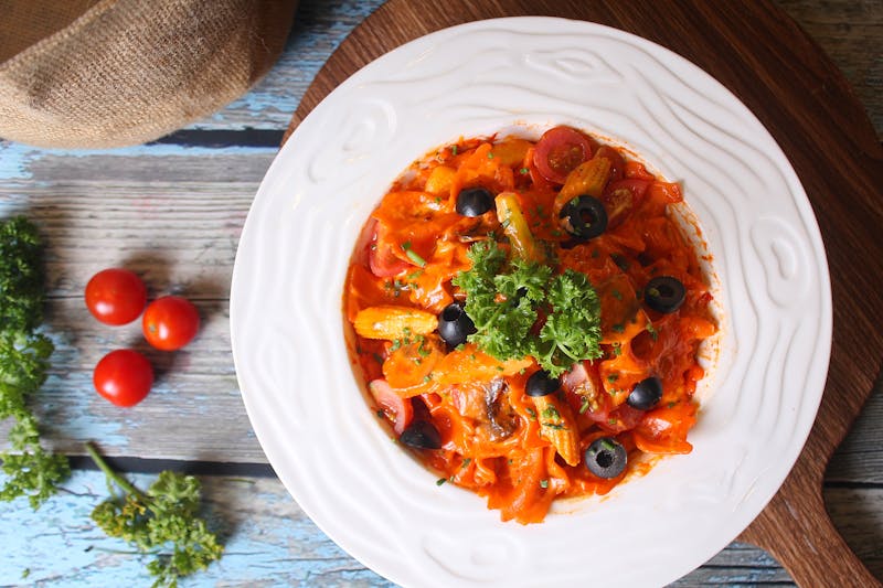 Penne Arrabbiata in spicy tomato sauce with fresh herbs